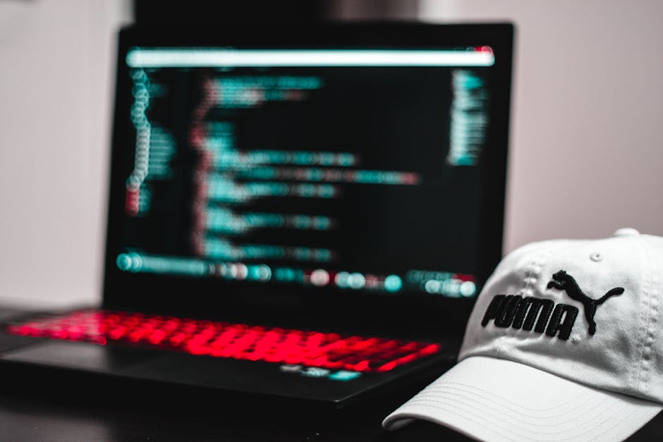 The image shows a computer screen displaying lines of HTML code in a dark-themed code editor, with the file named 'index.html' open. The code includes tags such as <html>, <head>, <title>, and <link>,